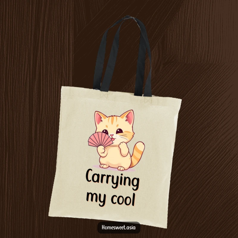 Funny cat wearing a tiny fan, playfully waving it with its paw, durable tote, stylish accessory, cute, funny gift.